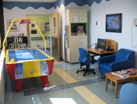 The air hockey game and comfortable chairs are part of the game room at Shelly's Place.
