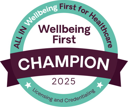 The Wellbeing First champion badge for 2025, with the text All IN Wellbeing, First for Healthcare. Licensing and Credentialing.