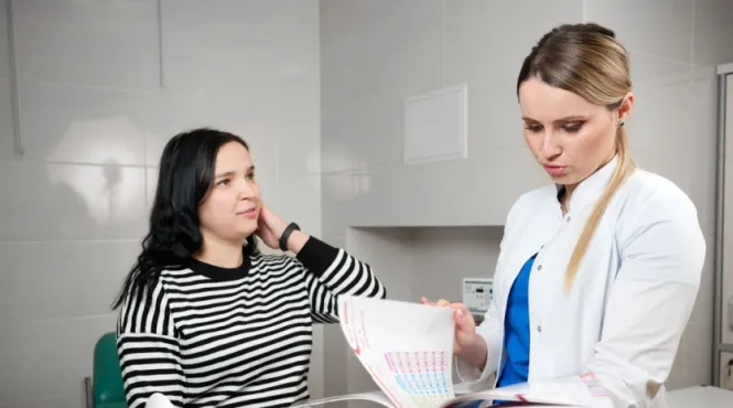 Woman in 20s at her first GYN appointment talking with the doctor