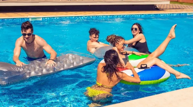 group of teens swimming in a pool