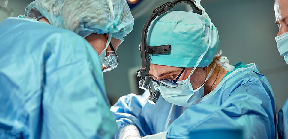 Surgeons are operating on a patient.