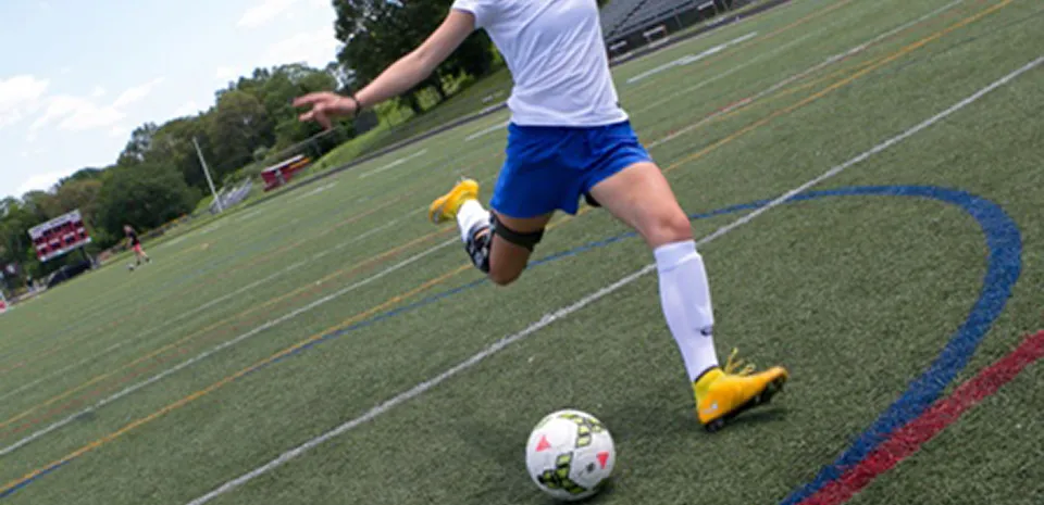 soccer player kicking soccer ball