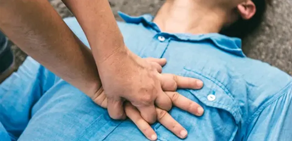 person giving CPR chest compressions