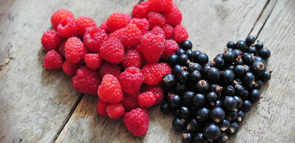 raspberries and blueberries shaped in hearts