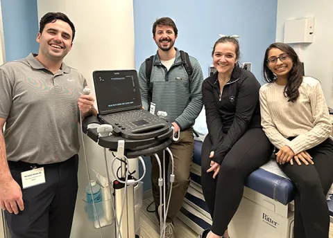  Physician Assistants and Acute Care Nurse Practitioners group together in a training area.