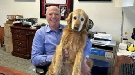 Doctor Eric Dickson with his dog, golden retriever