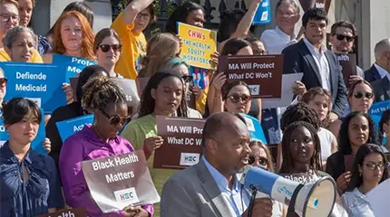 Michael Curry (front), president and CEO of the Massachusetts League of Community Health Centers, delivers remarks at a rally at the State House, July 15, before a legislative hearing for the Act to Improve Health Equity.