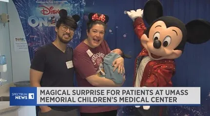 Mickey Mouse poses with patients and families at the Children's Medical Center during a visit.