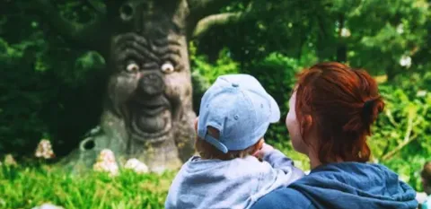 mother and child looking at mythical tree