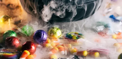 candy corn, chocolate, and Halloween candies all on a table