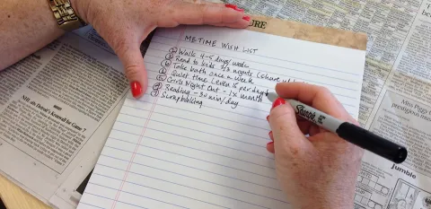 women writing a list for me time