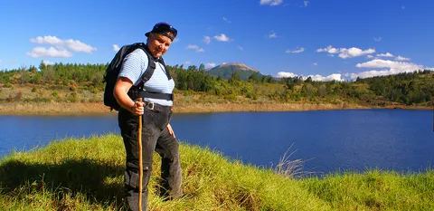 woman hiking with walking stick