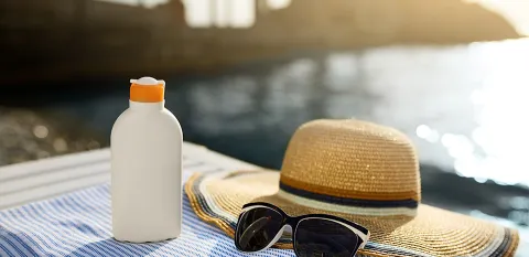 waterfront view sunglasses and woman's hat