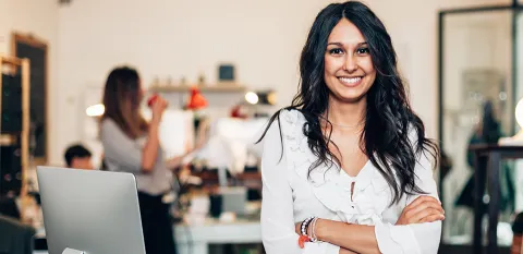 diverse woman standing smiling for the camera in office space