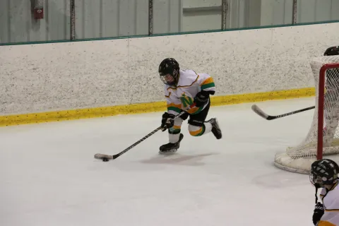 A hockey player is skating on the ice.