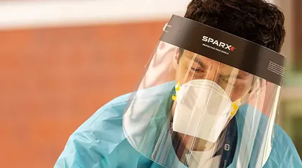 Dr. Evan Bradley, an emergency physician at UMass Memorial Healthcare, swabs a woman's nose at a COVID-19 testing and resource fair at Worcester Technical High School Monday on Aug. 10, 2020.
