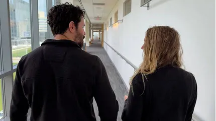 Lauren Murphy and husband Brian Rettger walk down a hallway in the University Campus' Ambulatory Care Center
