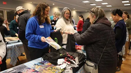 Community members assembling kits to deliver to children.