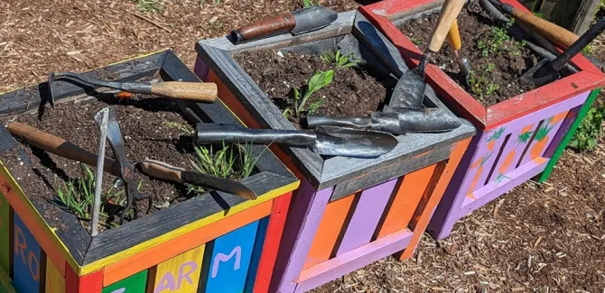 Planters display the gardening tools transformed by the Guns 2 Gardens organization.