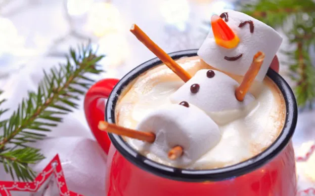 Red mug with hot chocolate and a melted marshmallow snowman
