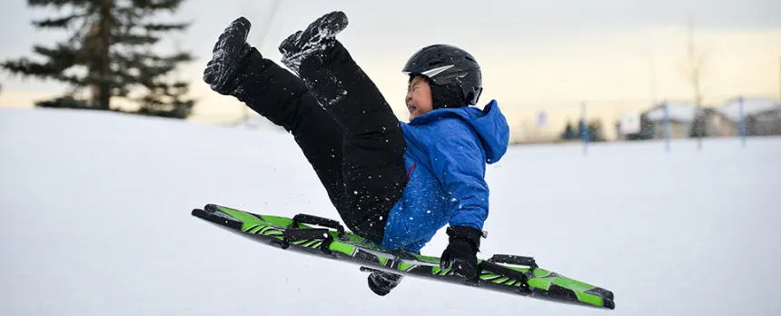 boy sledding in the snow