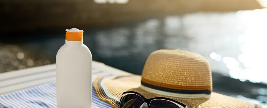 waterfront view sunglasses and woman's hat