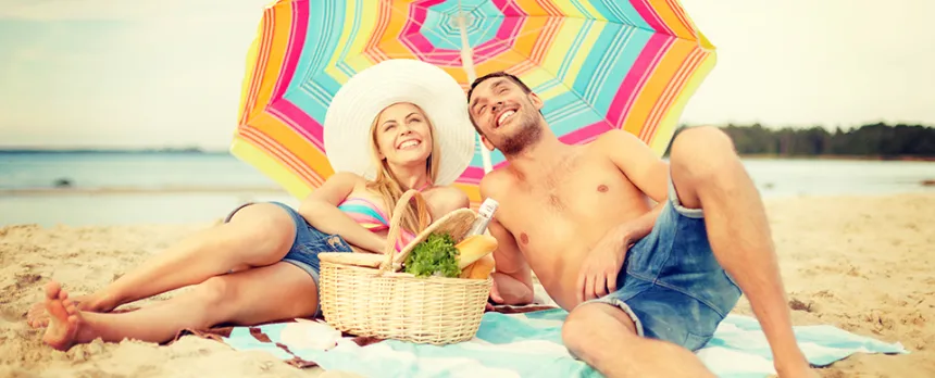 younger couple on the beach under the umbrella