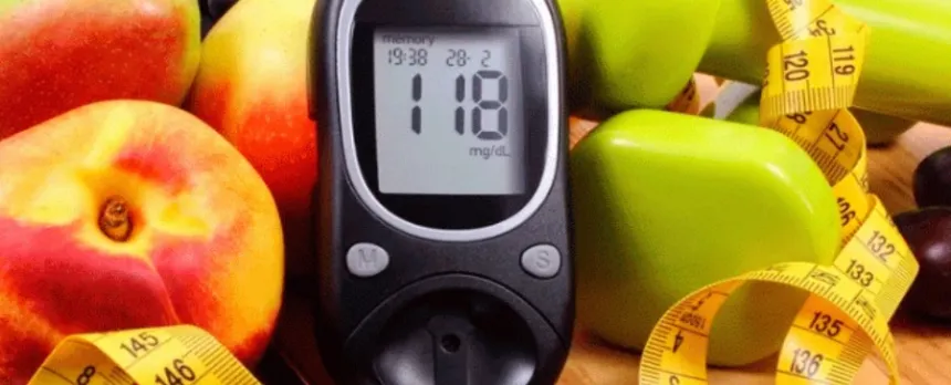 colorful fruits and veggies with a blood glucose monitor used to help achieve well controlled diabetes.