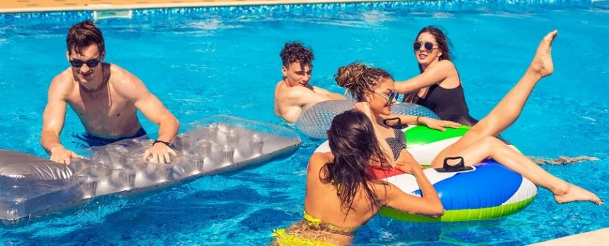 group of teens swimming in a pool