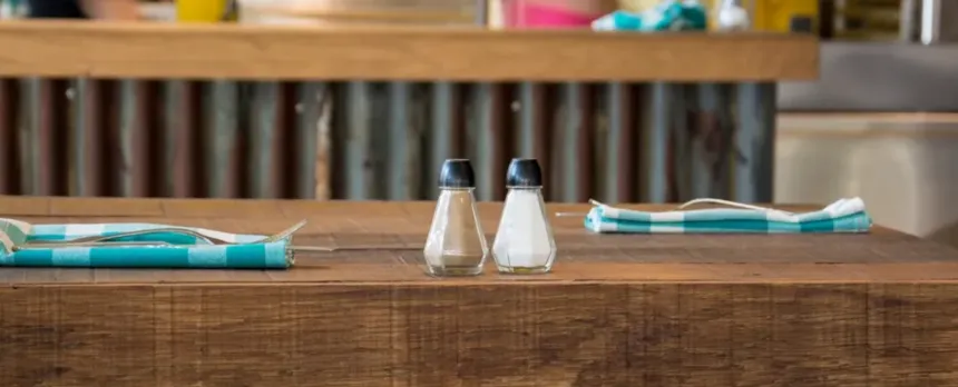 A salt and pepper shaker are sitting on a table.